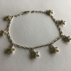 Silver tone metal anklet with stars dangles